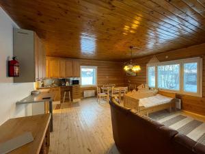 a kitchen and dining room of a log cabin at Wild Stay - Ounasrannan majat, Tepasto in Tepasto