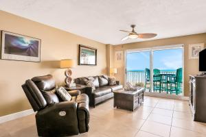 a living room with a couch and a table at Sand and Sea Enjoyment Retreat in Ormond Beach