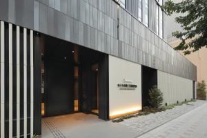 an external view of a building with large glass doors at Hotel Keihan Tenmabashi Ekimae in Osaka