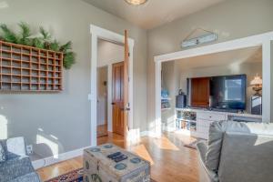 a living room with a couch and a tv at Mill House in Lincoln City