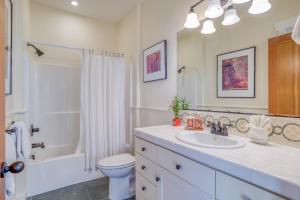 a white bathroom with a sink and a toilet at Mill House in Lincoln City +61 photos