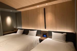 سرير أو أسرّة في غرفة في Hotel Keihan Tenmabashi Ekimae