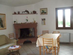 a living room with a table and a fireplace at B&B Tatti in Nughedu Santa Vittoria