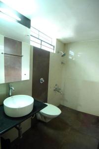a bathroom with a sink and a toilet at Shastri Paradise opst to KSRTC Bus Stand in Mysore