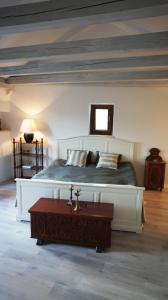 a bedroom with a large bed and a table at Holiday home Korta in Mali Ston