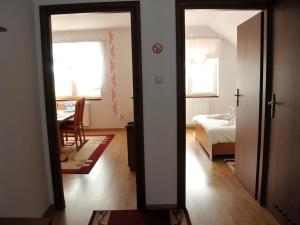a room with a door open to a room with a bedroom at Hotel Restauracja LORENZO in Stopnica