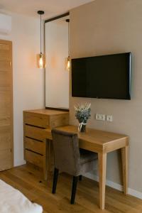 a room with a desk and a television on a wall at Schlosstaverne Thannhausen in Weiz +12 photos
