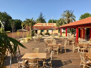 a bunch of tables and chairs on a deck at Charming Mobile Home in Argels-sur-Mer with Stunning Beach Views in Argelès-sur-Mer