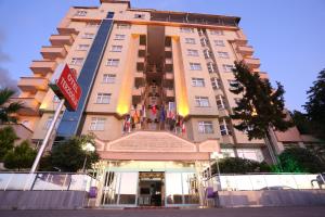 a tall building with a sign in front of it at Terzioglu Otel in Hopa