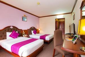 Postel nebo postele na pokoji v ubytování TTC Hotel - Da Lat