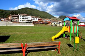 a park with a playground with a slide and a slideintend at Family Hotel Daisy in Borino