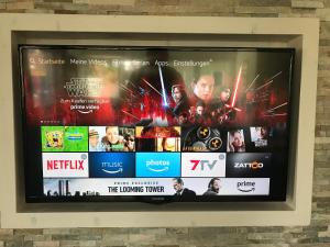 a television screen with a bunch of movies on it at Ferienwohnung Hella in Kippenheim