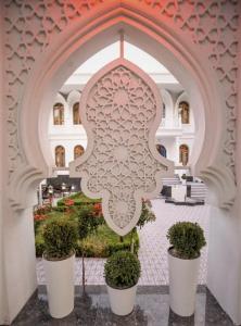 an archway with potted plants in a building at The Shahar in Tashkent