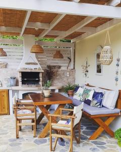 a patio with a table and a couch at Vague Summer House in Skiathos