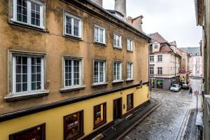 een steegje in een stad met een geel gebouw bij Rent like home - Ślusarska 13 in Poznań