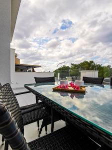 a dining table on the roof of a house at Phaedrus Living - Seaside Deluxe Flat Harbour 107 in Paphos