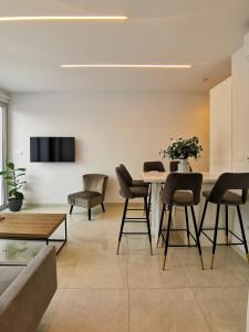 uma sala de estar com mesa e cadeiras em Phaedrus Living - Seaside Deluxe Flat Harbour 107 em Pafos