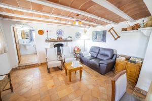 a living room with a couch and a fireplace at Villa Son Fullos in Santa Margalida +37 photos