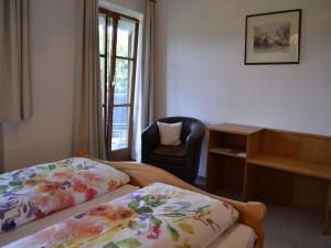 a hotel room with two beds and a chair at Pichler Roswitha in Bad Endorf +20 photos