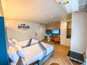 a bedroom with a bed and a television at Days Inn by Wyndham Patong Beach Phuket - SHA Extra Plus in Patong Beach