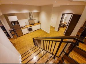 a room with a staircase leading to a kitchen at Puri Mediterania Semarang in Kalibanteng-lor