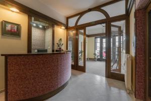 an office lobby with a reception counter and a door at Hotel Amco in Zábřeh