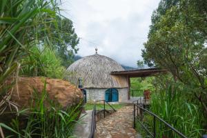 
a small village with a large stone wall at Dream Cliff Mountain Resort in Haputale
