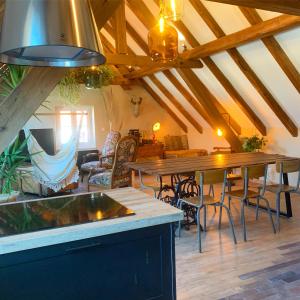 a dining room with wooden tables and chairs at Gîte de charme à la campagne, proche de Strasbourg in Fessenheim-le-Bas