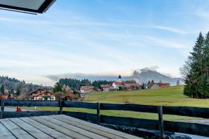 a view of a village with a mountain in the background at Hygge in Ofterschwang