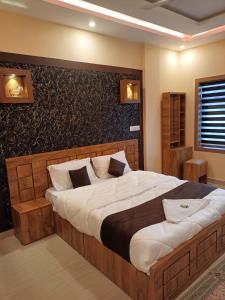 a bedroom with a large bed in a room at LetStay Misty Wind Holiday Homes in Vythiri