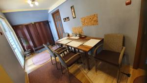 a dining room with a table and chairs at Casa mea de vacanta in Baia-Sprie