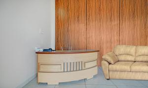 a wooden desk and a chair in a room at Treebo Trend Alankar Hoshangabad Road in Bhopal