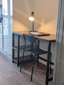 a desk with a chair and a lamp on it at Middlehaven Studio in Middlesbrough
