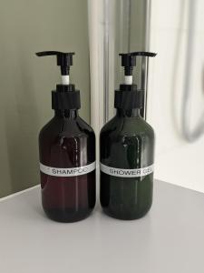 two bottles of soap sitting on a shelf at Middlehaven Studio in Middlesbrough