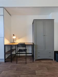 a desk with a chair and a cabinet in a room at Middlehaven Studio in Middlesbrough