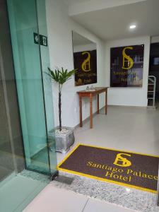 a room with a table and a glass wall at Santiago Palace Hotel in São João del Rei