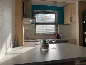 a kitchen with a glass of wine on a counter at Abatilles in Arcachon