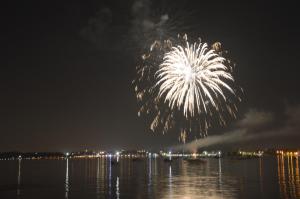 a firework display over the water at night at Hotel Bella Italia in Peschiera del Garda
