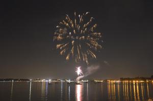 a firework display over the water at night at Hotel Bella Italia in Peschiera del Garda
