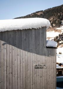 a wooden structure with snow on top of it at Boutique & Gourmet Hotel Orso Grigio in San Candido