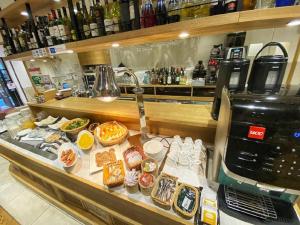 a counter with many different types of food on display at Hotel Rose Garden Shinjuku in Tokyo