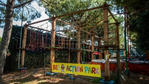 a playground in a park with a roller coaster at Hotel Bella Italia in Peschiera del Garda