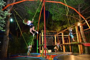 a group of people jumping on a rope at Hotel Bella Italia in Peschiera del Garda