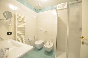a bathroom with a sink and a toilet and a shower at Hotel Bella Italia in Peschiera del Garda