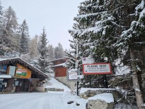 a sign in the snow in front of a building at The little refuge of La Plagne (French Alps) in Plagne 1800