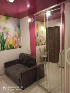 a bathroom with a shower and a painting on the wall at Gościnne Gniazdo in Będzin
