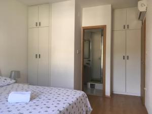 a bedroom with a bed and white cabinets and a mirror at Apartment in Povlja with sea view, terrace, air conditioning, WiFi 3419-1 in Povlja