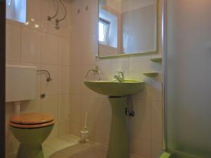 a bathroom with a sink and a toilet and a mirror at Apartment in Povlja with sea view, terrace, air conditioning, WiFi 3419-1 in Povlja +29 photos
