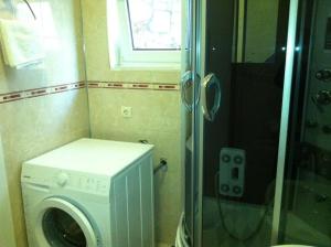 a washing machine in a bathroom with a window at Apartment in Povlja with sea view, terrace, air conditioning, WiFi 3419-1 in Povlja