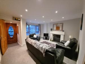 a living room with two couches and a fireplace at The Townhouse, Derry City Centre. in Derry Londonderry